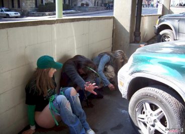 st patrick day girls peeing in public hiding against a high wall