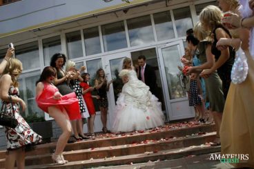 bridemaids having oops upskirt while groom and bride is walking down the stairs