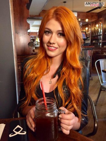 hottest redhead babe in a bar having a drink