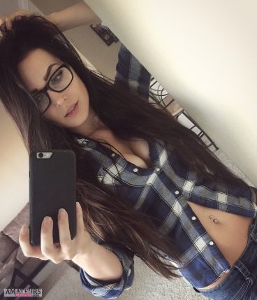 Big sexy cleavage of hot college girl wearing a blouse and glasses