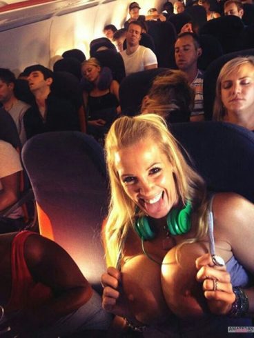 Busty girl flashing her big tits in airplane while people sleeping