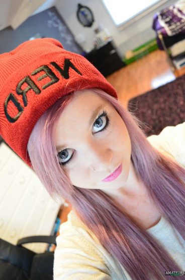 Pink hair ginger girl with cap on selfie picture