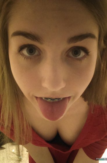 Sweet teen girl with braces sticking her tongue out teaser FI